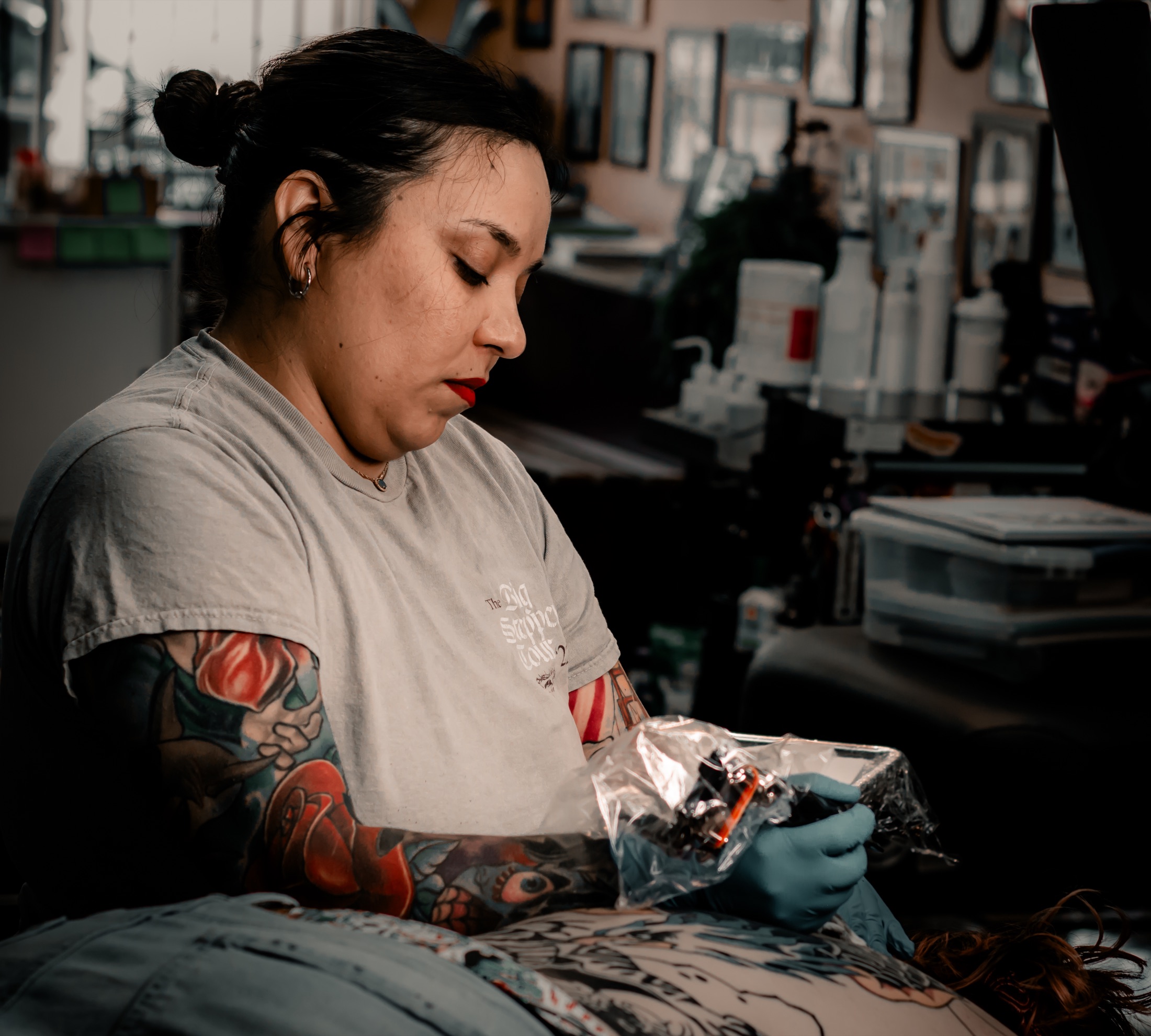 Christina tattooing a client inside the studio